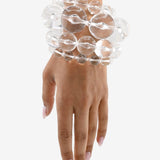 Clear, glass-like lucite bracelet stack on a wrist